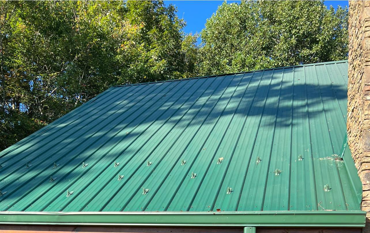 The same metal roof after the wash, with the panel colour back