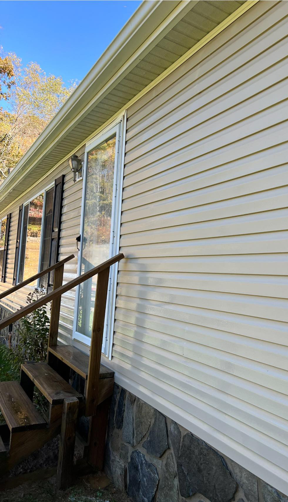 Home siding after cleaning, shiny, clean, with all visible grime removed.